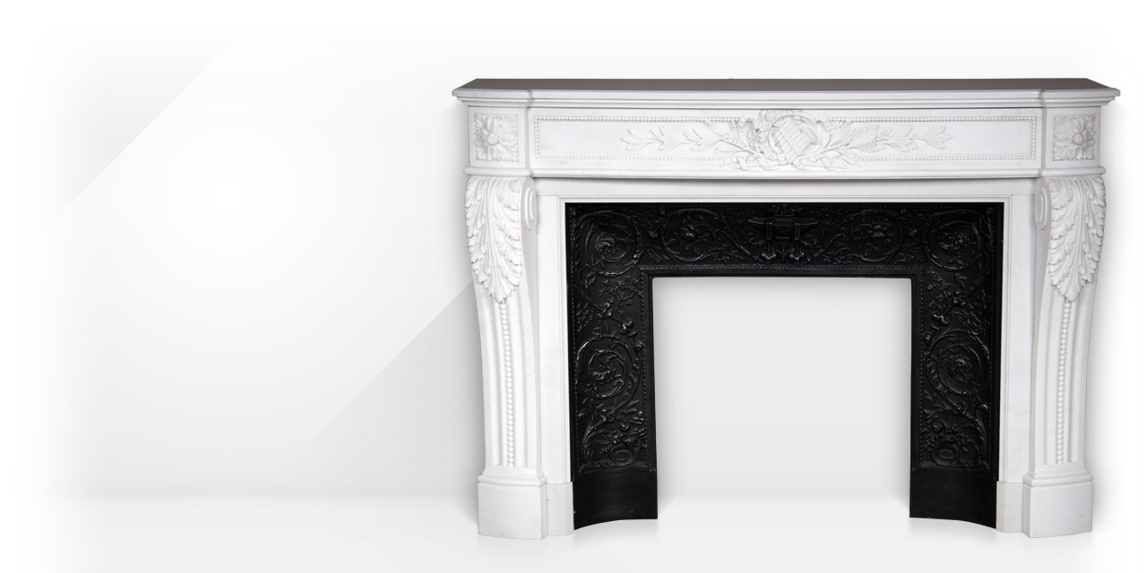 Arcadia is a custom-made Louis XVI style fireplace mantel made out of marble, with a curved entablature and with a pan flute and floral carving. 