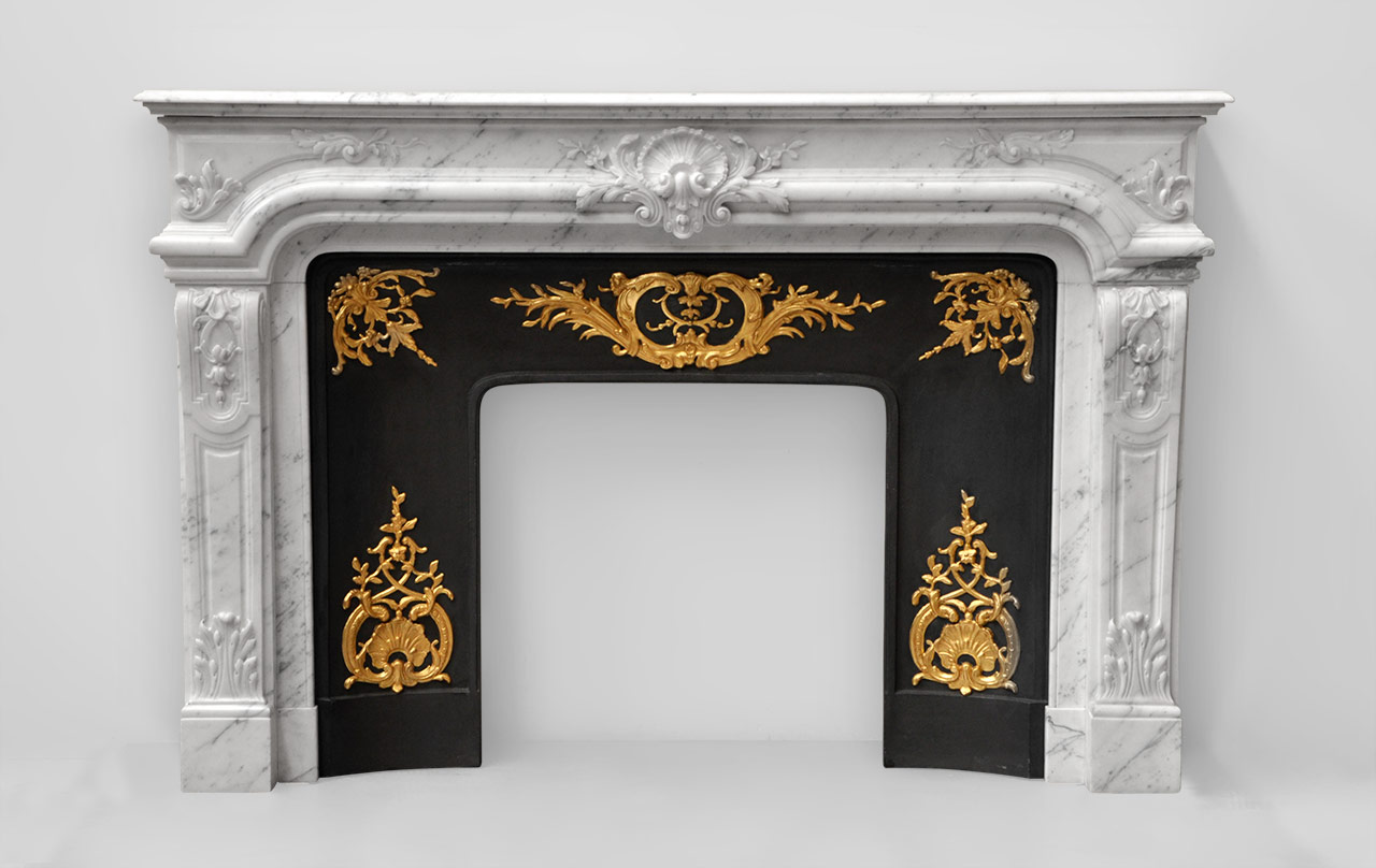 “Vendome” is a Regence style fireplace made out of white veined Carrara marble that combines both sophistication and elegance.
Its sober lines are adorned with a remarkable sculpted decoration. The curved jambs, covered with molded panels, are garnished with lush acanthus leaves. The entablature is the result of exceptional sculpting work.
This fireplace comes with its gilded cast iron insert. The reliefs are gilded with gold leaf.